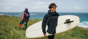 man-in-finisterre-clothing-holding-a-surf-board