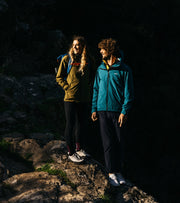 Pair standing on a rock with mountainous background